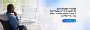 La imagen muestra un entorno de oficina iluminado, donde un hombre está sentado de espaldas a la cámara, concentrado en una pantalla de computadora frente a él. La pantalla muestra gráficos y análisis de datos. 